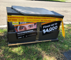 Trash can with sign which says: "find the missing $4,000". 