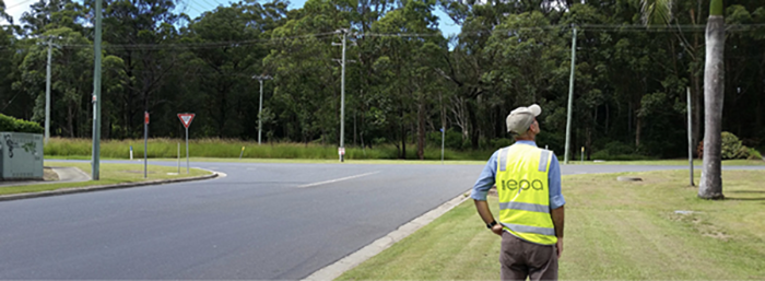 EPA inspector in hi vis vest on grassed road verge