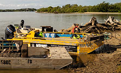 Clean-up crews collect and remove debris from the river