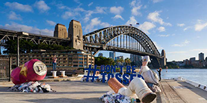 giant drink can and cigarette butt, part of the litter campaign outside the overseas passenger terminal with the Sydney Harbour Bridge in the background