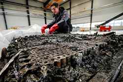 A technician checks the possible remaining voltage of a completely burned Lithium-ion car battery before its dismantling by the German recycling firm Accurec in Krefeld, Germany, November 16, 2017. Picture taken November 16, 2017. 