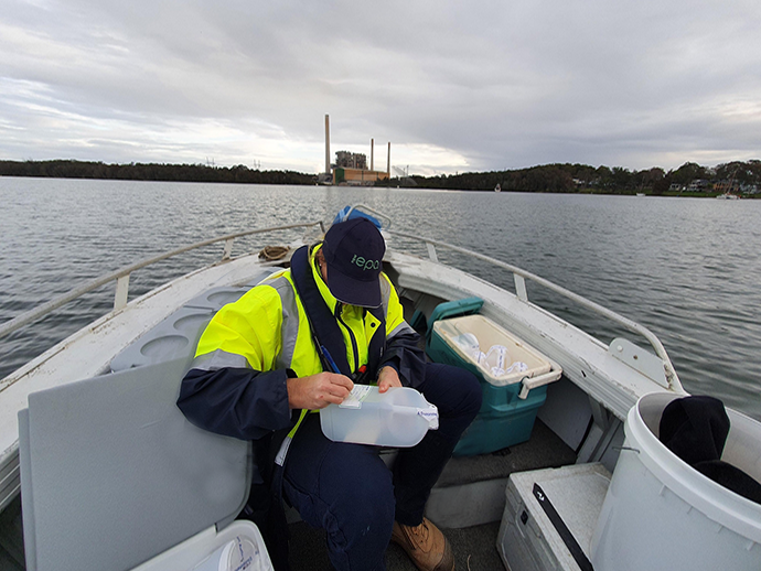 EPA officer in a boat preparing to sample water