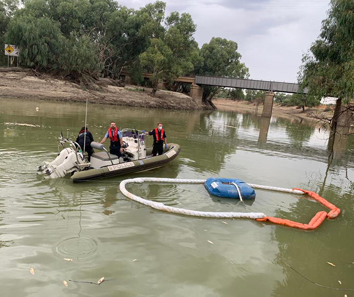 3 officers in a boat on the Darling River
