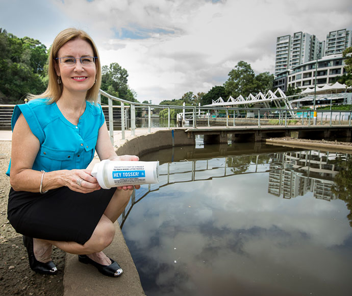 Minister for the Environment, Local Government and Heritage Gabrielle Upton tossing a GPS tracker bottle into the Parramatta River