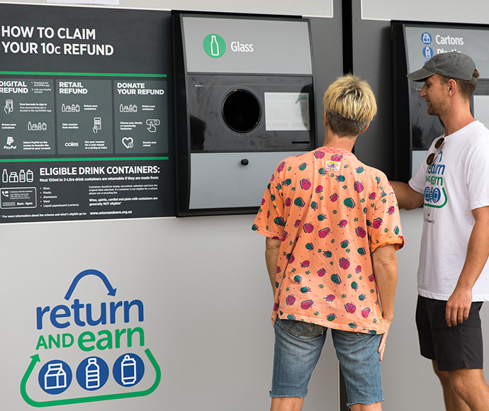 people using return and earn reverse vending machine