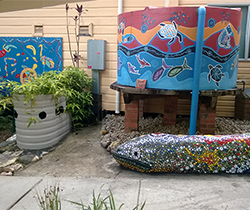 water tank and veggie garden backingspainted with indigenous themes