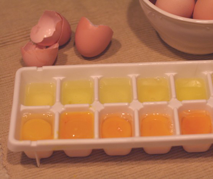 egg whites and yolks in ice block tray ready to freeze