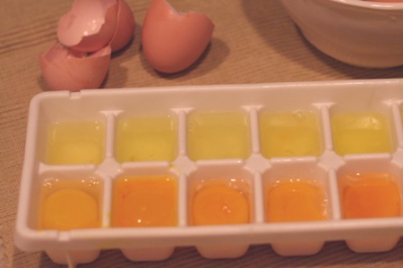 egg whites and yolks in ice block tray ready to freeze