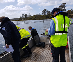 EPA staff collecting oil samples from Pambula Lake