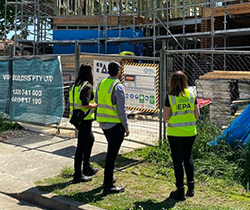 three EPA inspectors in hi vis vests at a building site