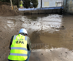 an EPA officer in hi vis vest inspecting runoff