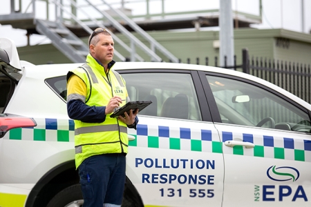 EPA officer beside a car branded EPA pollution response