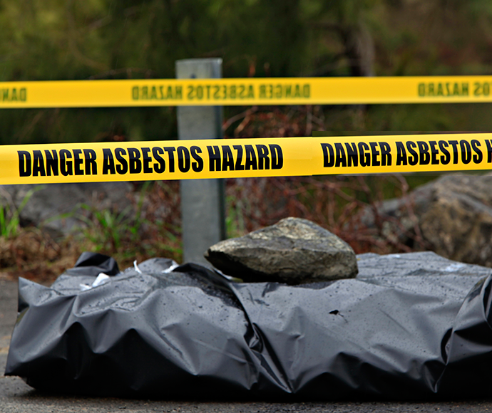 asbestos warning tape around dumped asbestos waste