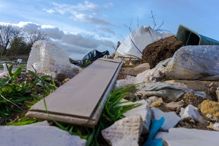 pile of illegally dumped rubbish on public
