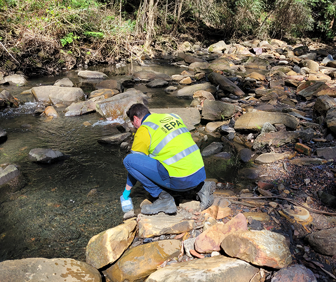 An EPA officer sampling water in Camp Gully Creek