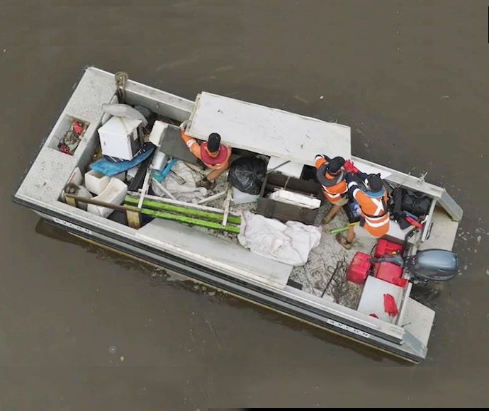 Aerial view of boat with sonar equipment to detect flood debris