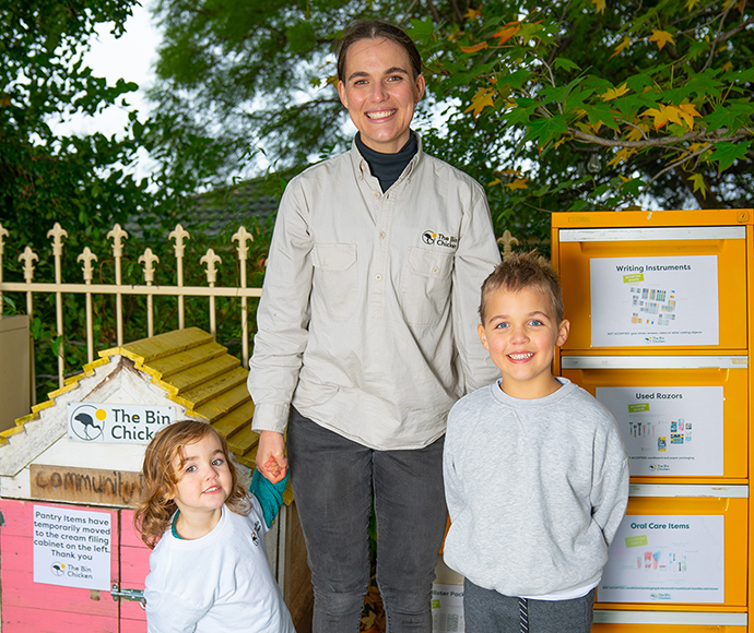 The Bin Chicken’s Alexis Bowen and children in front of recycling bins 