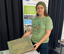 Earthcare Game’s Lia Wriley displays her enviro board game at the Enviro Ed conference 