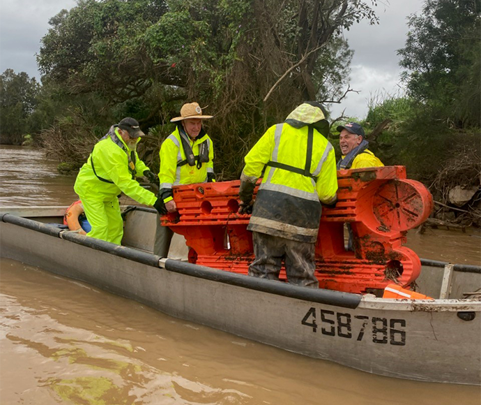 team helps remove debris from flood waters