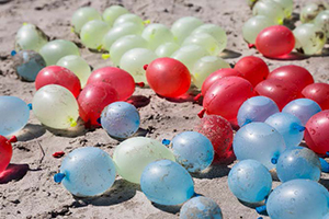 Water-filled balloons littering a beach