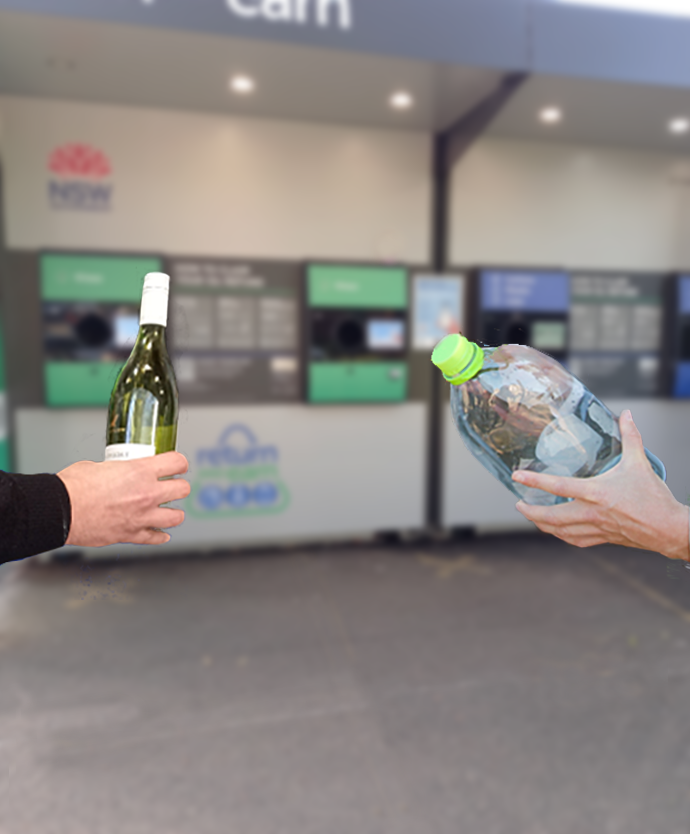 hands holding a wine bottle and large plastic container in front of CDS machine