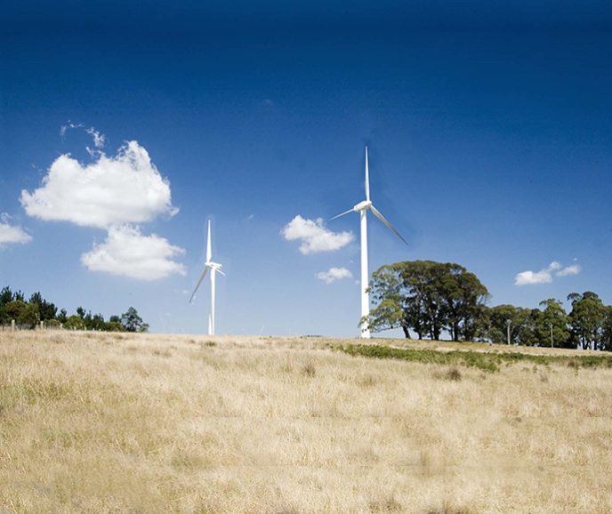 two wind turbines on a hill
