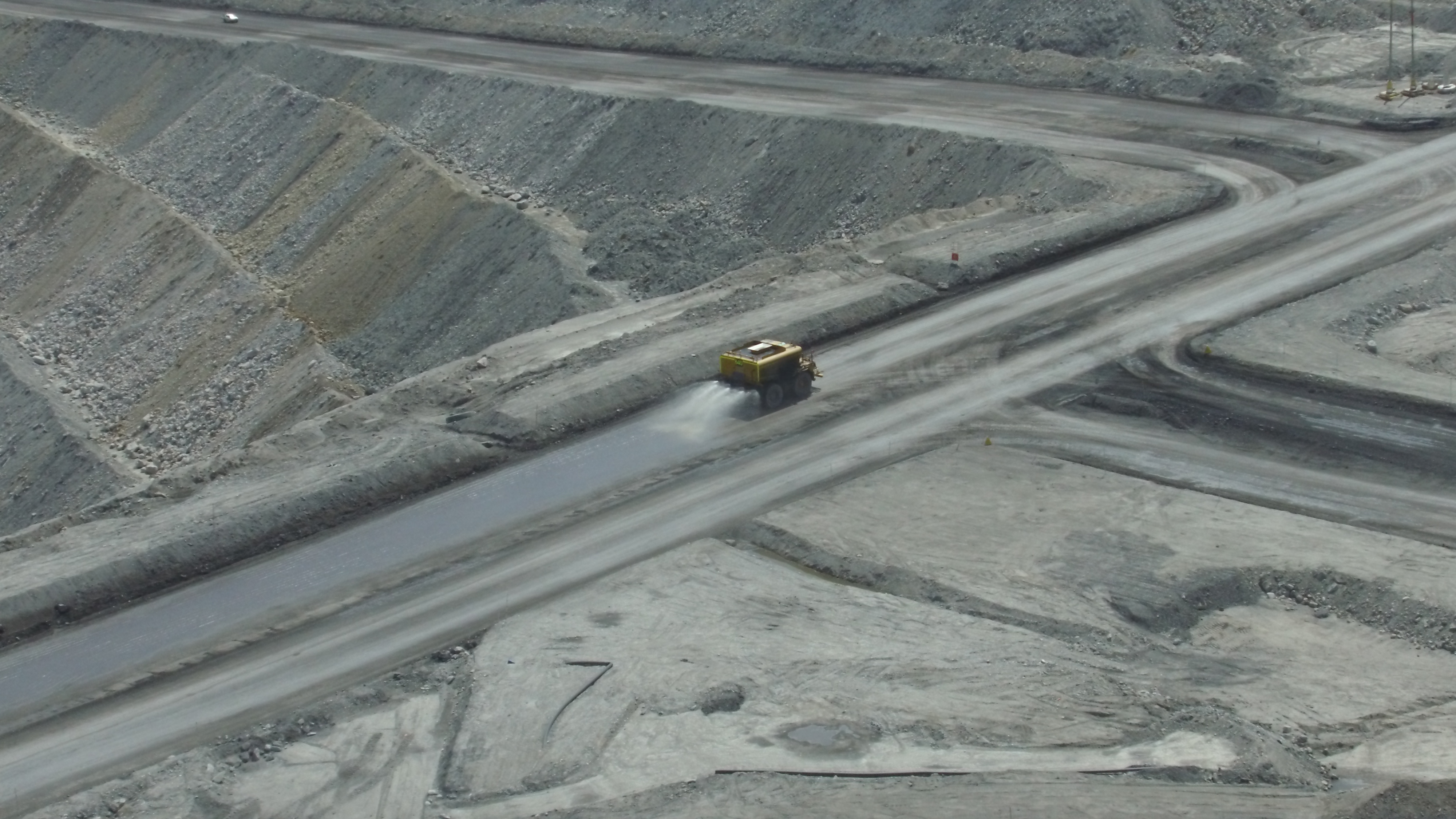 A truck drives in a mining area.