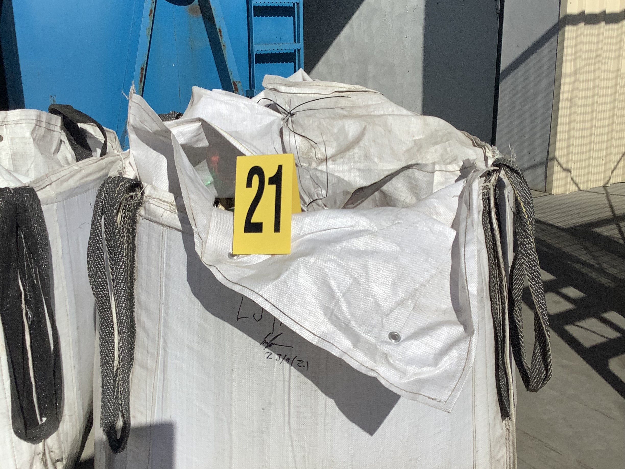 Large white bag filled with containers