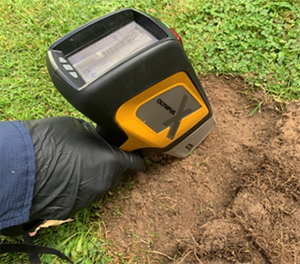 hand-held X-ray fluorescence analyser being used to test soil samples