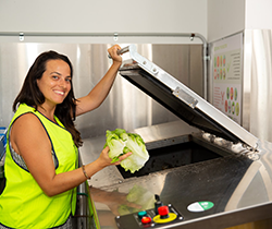 woman adding organics to recycling bin