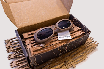 box with holding sun glasses packaged in perforated cardboard