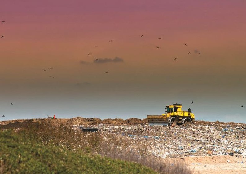 Compactor on landfill