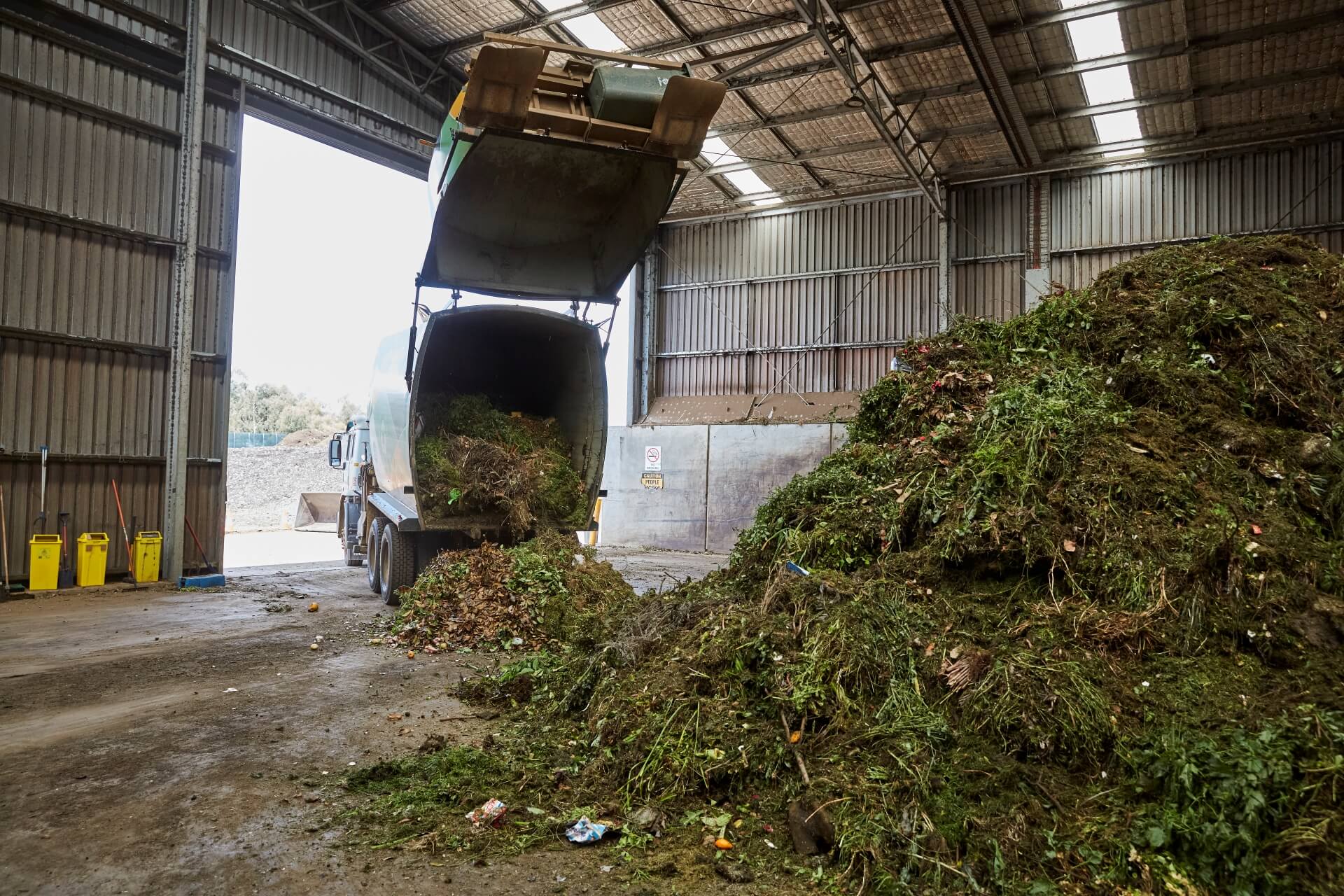 Truck dropping green waste off at commercial composting facility